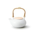 Casane Te Sakura Dobin Teapot with pink Sakura lid and white porcelain body, rattan handle, side view