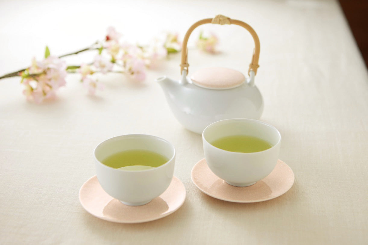 Casane Te Sakura Plate 13cm pink porcelain as saucer under Sencha Teacup with dobin teapot and cherry blossom lifestyle