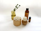 Kaminoka aroma diffuser lifestyle scene with paper flower baskets, essential oil bottles and glass vase