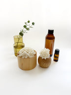 Kaminoka aroma diffuser vertical lifestyle with paper flower baskets, glass vase and essential oil bottles