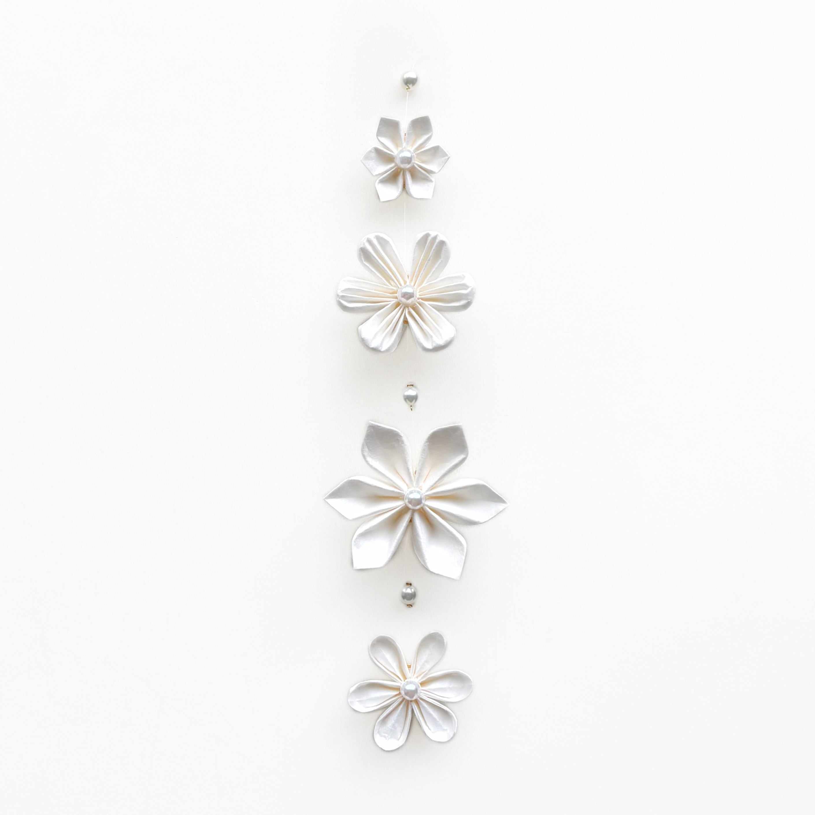 Kaminoka Type A washi paper flower mobile, vertical arrangement of white folded flowers on white background