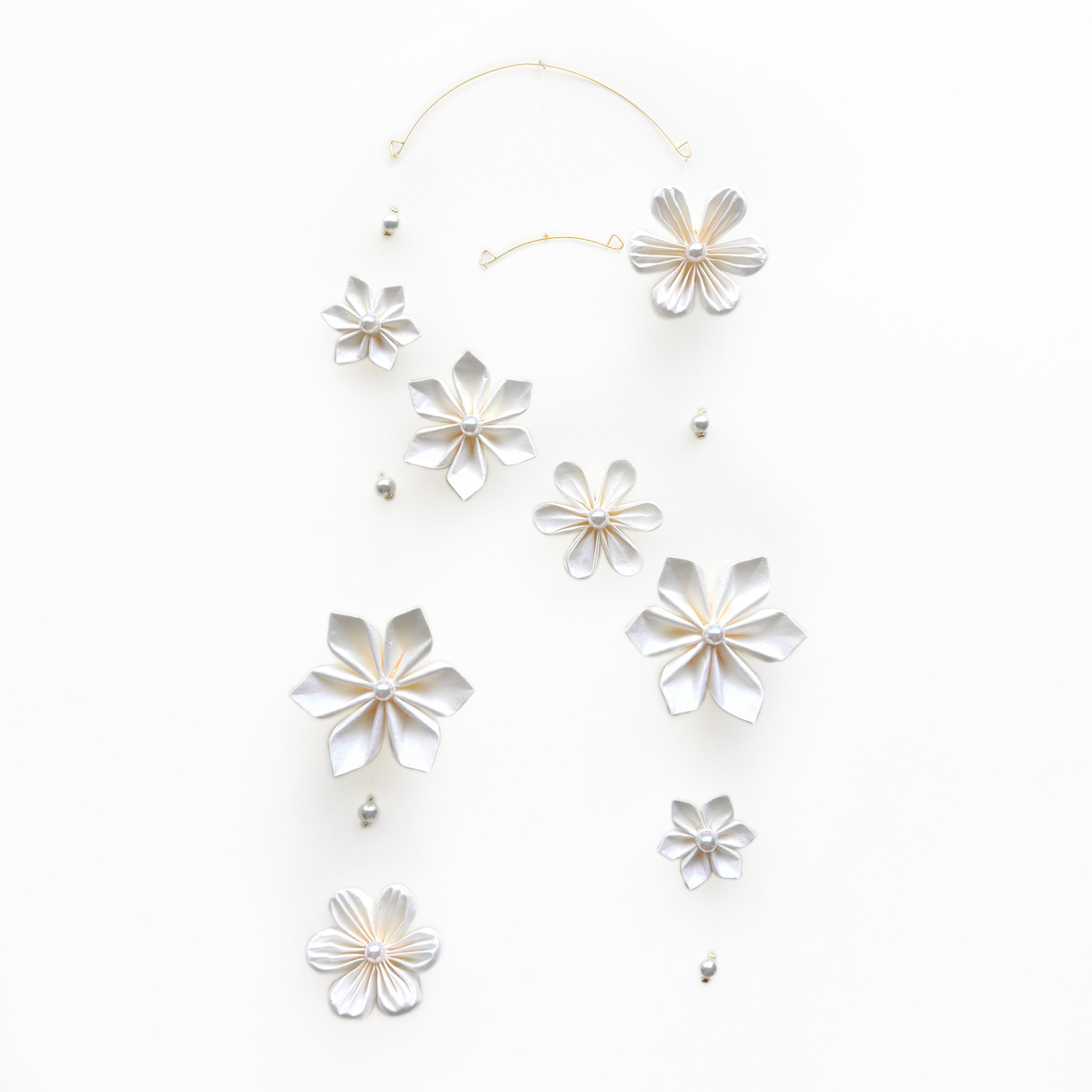 Kaminoka washi paper flower mobile with white folded flowers on a brass wire frame