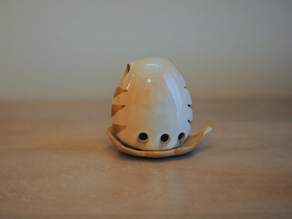 Japanese Owl Incense Stick Stand on neutral tan surface, lifestyle back view