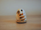 Japanese Owl Incense Stick Stand profile view showing facial details on tan surface