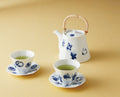 Shichifuku Seven Lucky Gods tea set with dobin teapot, sencha teacups and saucers in white porcelain with blue glaze, lifestyle