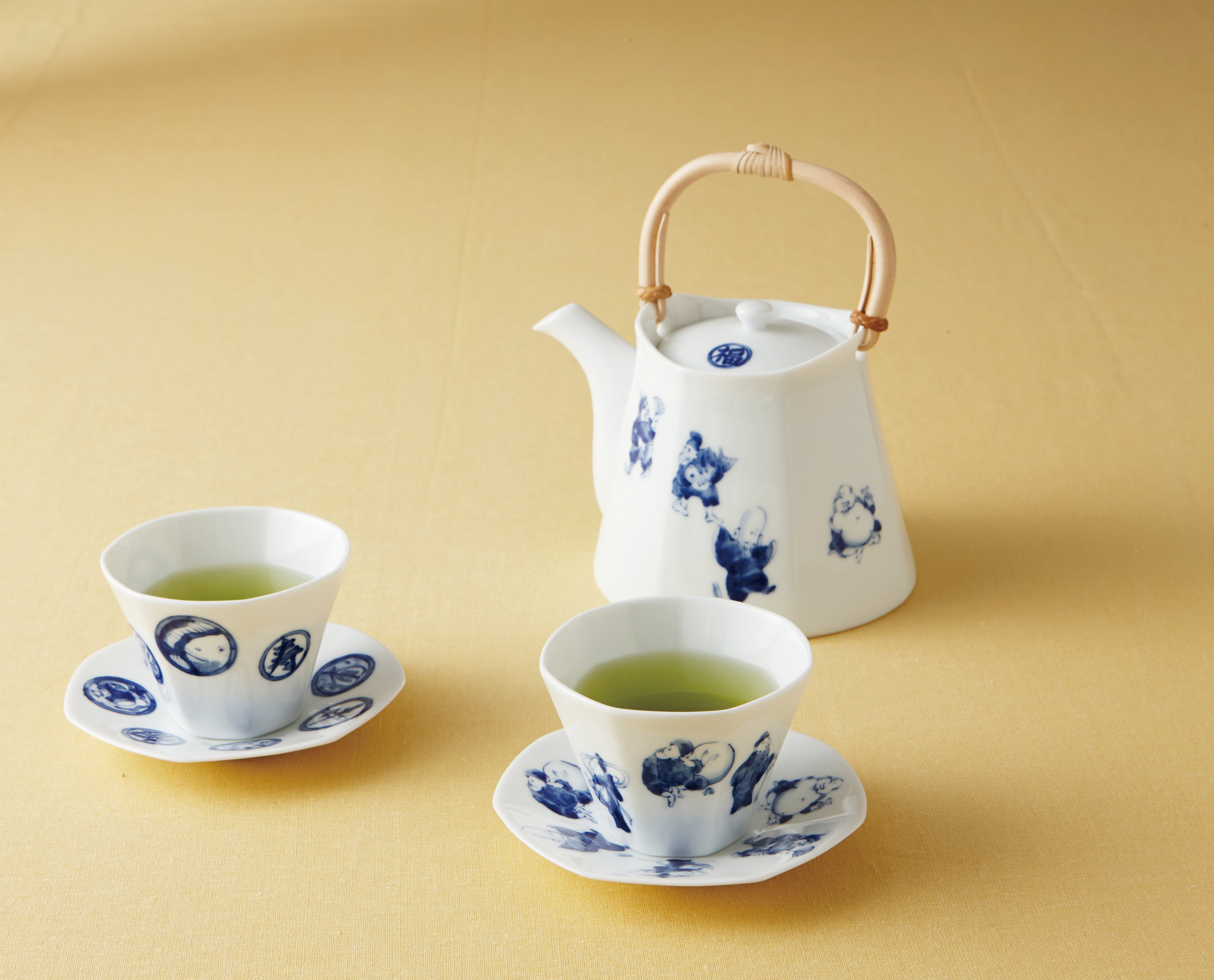 Shichifuku Seven Lucky Gods tea set with dobin teapot, sencha teacups and saucers in white porcelain with blue glaze, lifestyle
