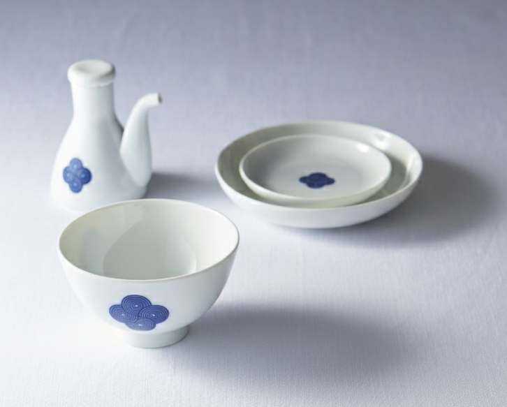 Washokki Dining Set with blue Sometsuke swirl pattern showing soy sauce pitcher, plates and bowl on white surface