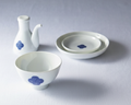 Washokki Dining Set with blue Sometsuke swirl pattern showing soy sauce pitcher, plates and bowl on white surface