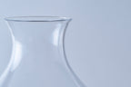 Detailed close-up of the smooth, tapered rim and elegant neck of a hand-blown artisanal beer glass.