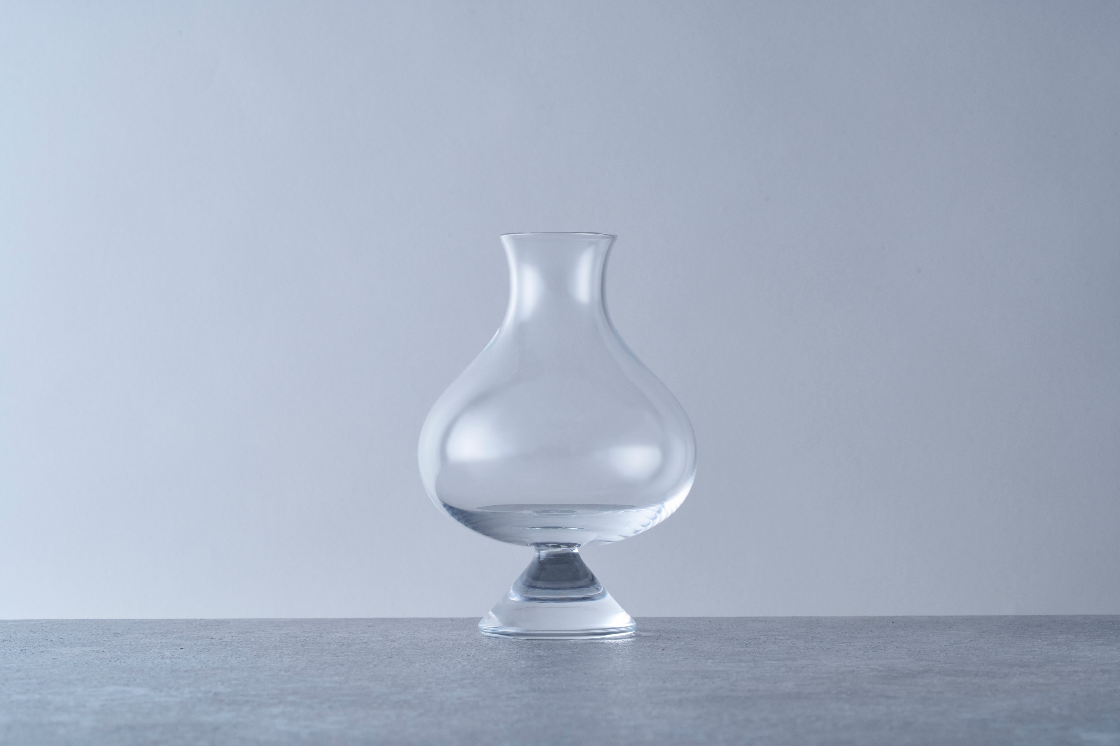 Clear thistle-style small size beer glass with a pedestal base and flared rim. Specialty glassware designed to enhance aromatics for Belgian ales, stouts, and craft beers.