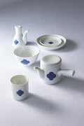 White Japanese porcelain **tea and dining set** with a **blue and white sometsuke floral swirl pattern**, showcasing the teapot, cup, bowl, and plate.