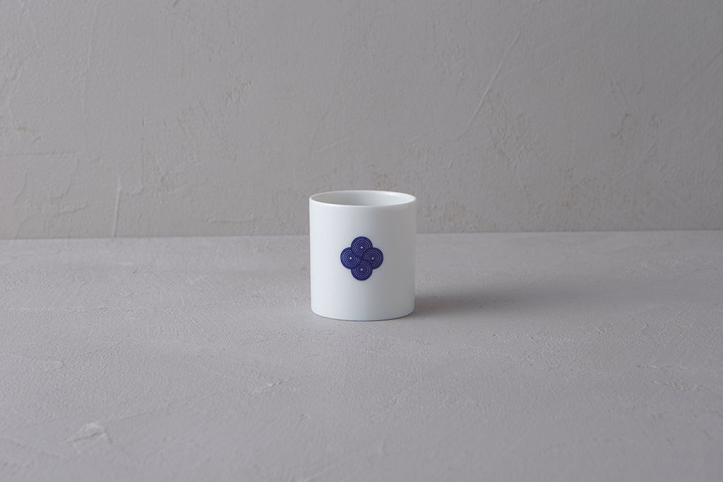 Single white Japanese **Yunomi** teacup featuring a prominent **blue and white Sometsuke swirl pattern** on the side.