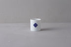 Single white Japanese **Yunomi** teacup featuring a prominent **blue and white Sometsuke swirl pattern** on the side.