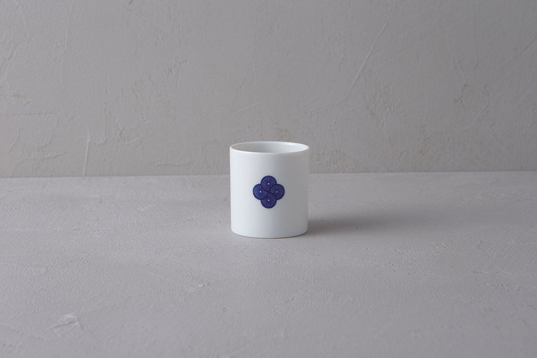 Single white Japanese **Yunomi** teacup featuring a prominent **blue and white Sometsuke swirl pattern** on the side.