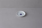 Small white **Japanese porcelain plate** featuring a single **blue and white Sometsuke swirl design** in the center.