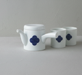 Two white Japanese **Yunomi** teacups and a matching **porcelain teapot** (kyūsu), all featuring the prominent **blue and white Sometsuke swirl pattern**.