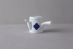 White Japanese **porcelain teapot** (kyūsu) with a side handle, decorated with a **blue and white Sometsuke swirl pattern** on the body.