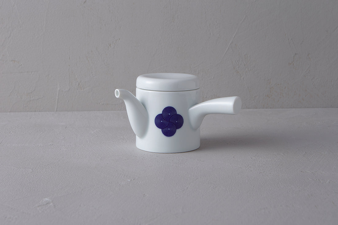 White Japanese **porcelain teapot** (kyūsu) with a side handle, decorated with a **blue and white Sometsuke swirl pattern** on the body.